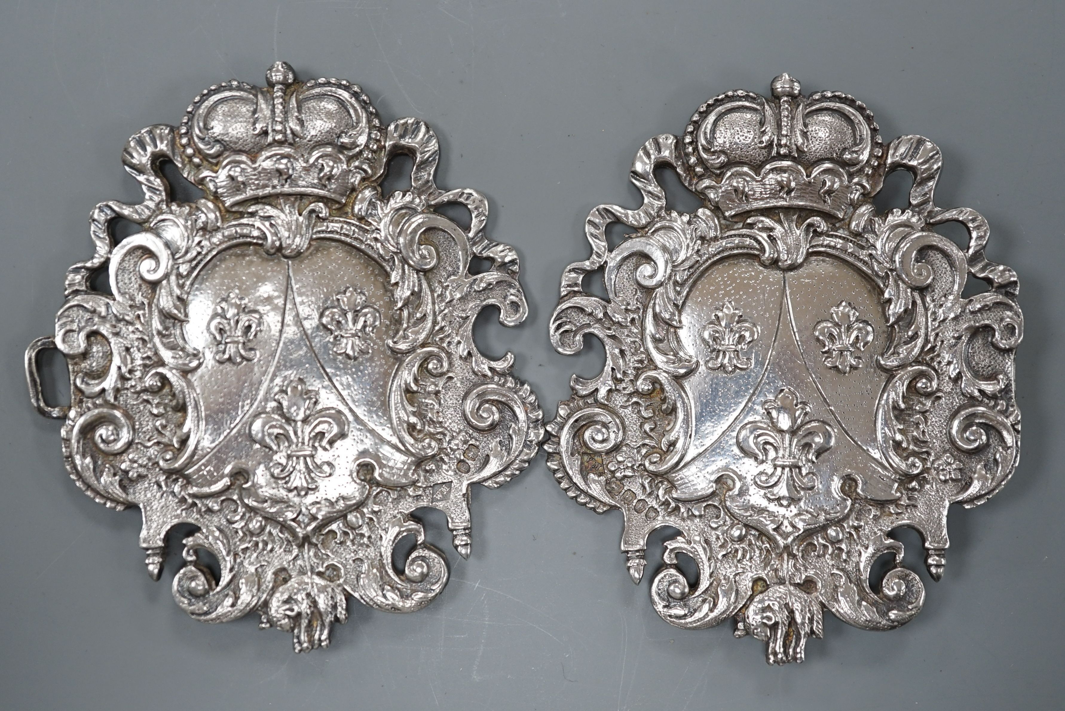 An 18th century Continental white metal belt buckle, modelled with the arms of the House of Bourbon and the Order of the Golden Fleece, height 7.5cm width overall 12cm, weight 66 grams